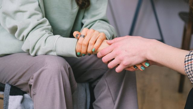 two people holding hands showing importance of interfaith connection